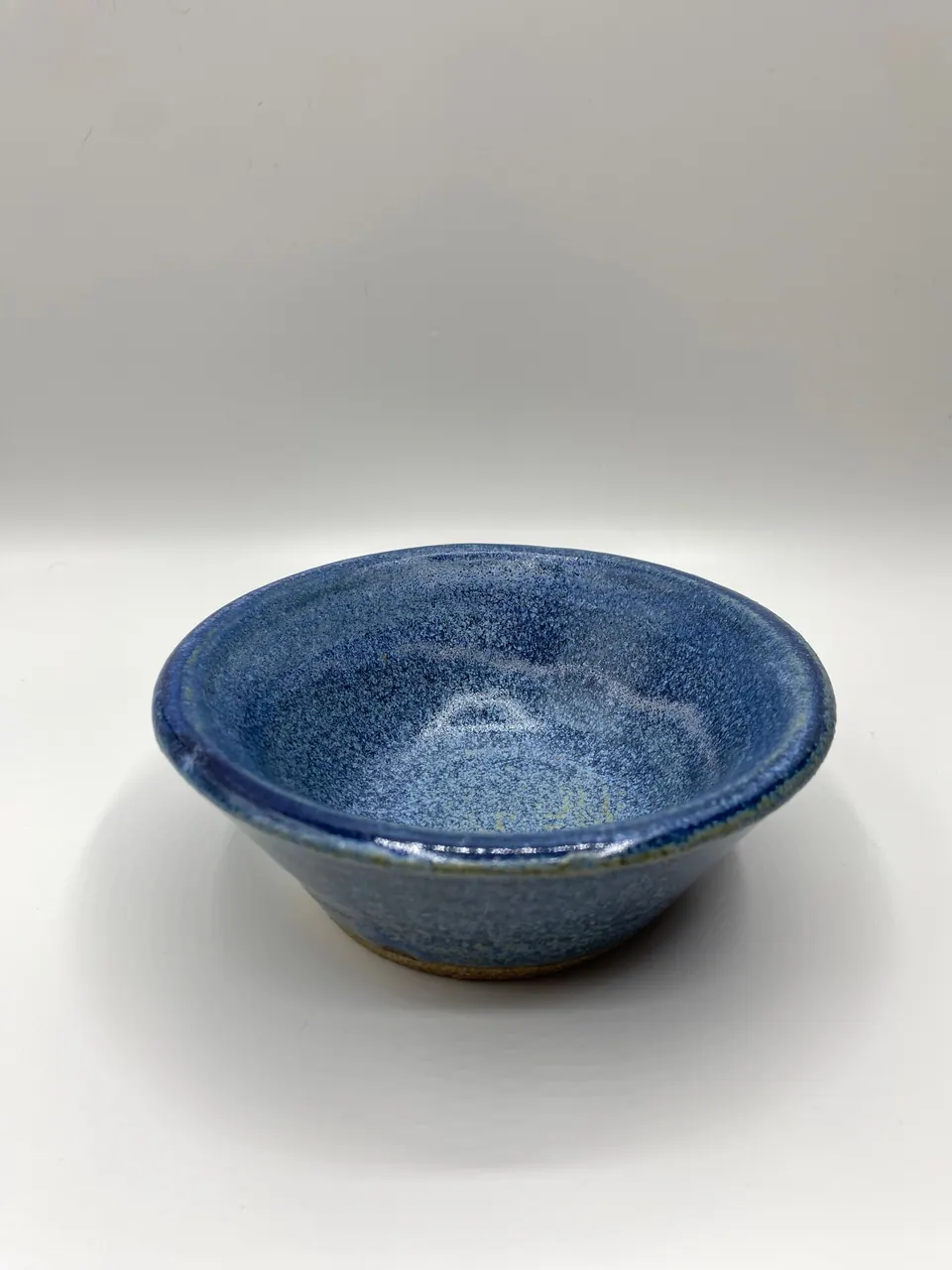 Flared ceramic bowl in a speckled cobalt blue glaze