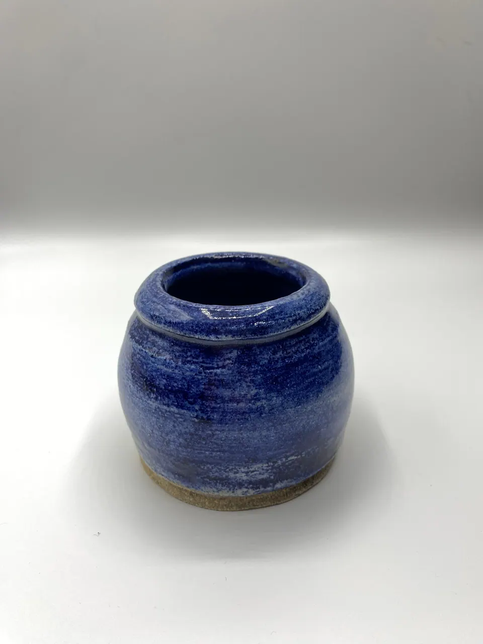 Small rounded ceramic jar with brushed bands of cobalt blue glaze